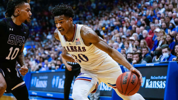 Dec 18, 2021; Lawrence, Kansas, USA; Kansas Jayhawks guard Ochai Agbaji (30) drives against Stephen F. Austin Lumberjacks guard Latrell Jossell (10) during the second half at Allen Fieldhouse. Mandatory Credit: Jay Biggerstaff-USA TODAY Sports